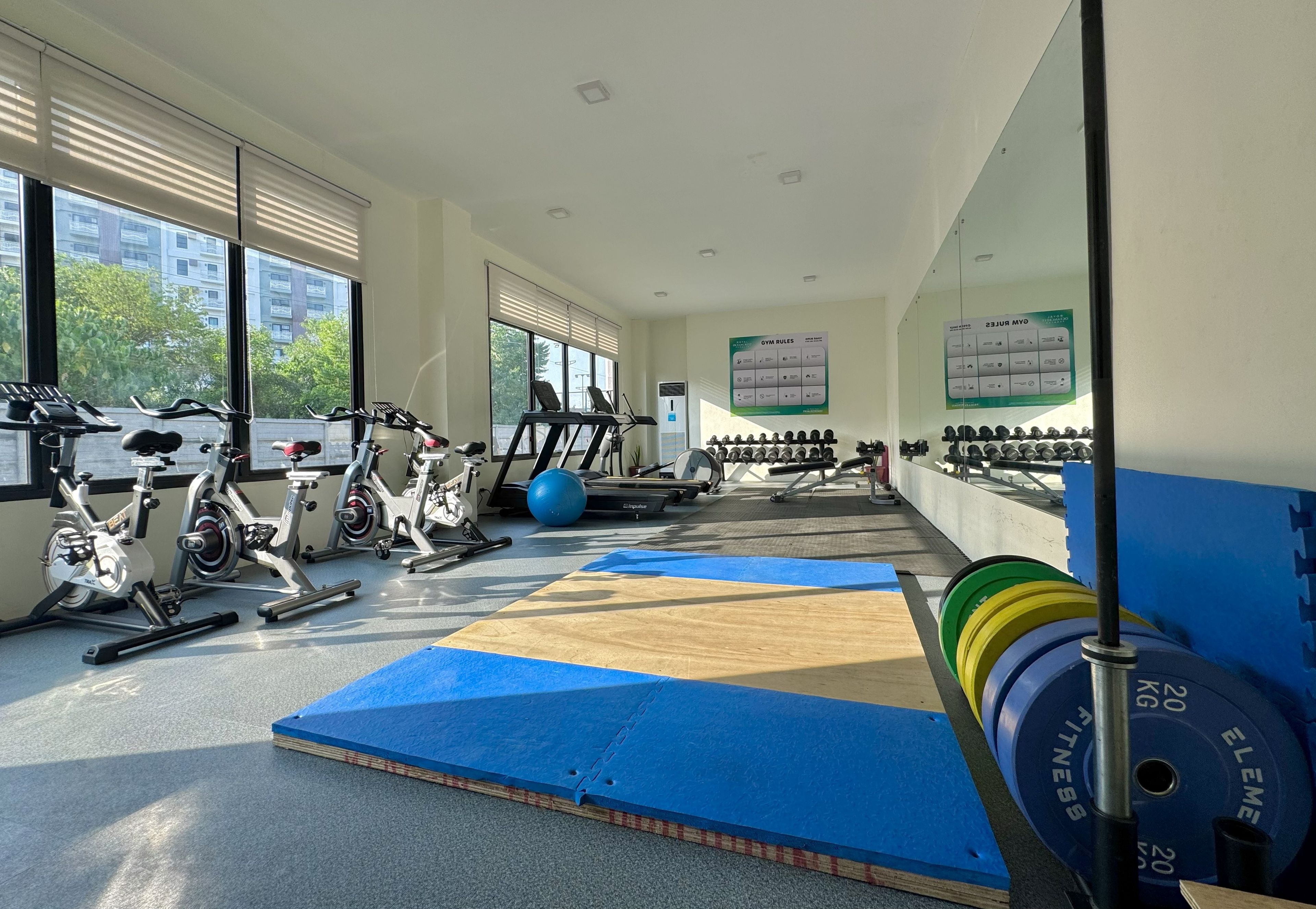 A gym with exercise equipment, mats, and weights.
