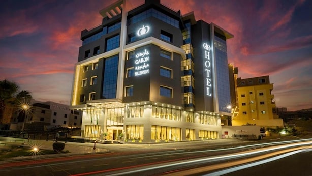 A multi-story hotel with a modern design, featuring a prominent 'HOTEL' sign on the facade. - Gardn Millennium Hotel Abha (Abha)
