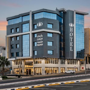 A modern hotel with a prominent 'HOTEL' sign on the facade, featuring a glass and concrete exterior. - Gardn Millennium Hotel Abha (Abha)