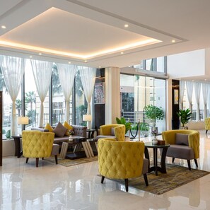 A modern lobby with a seating area, large windows, and a view of the outdoors. - Gardn Millennium Hotel Abha (Abha)