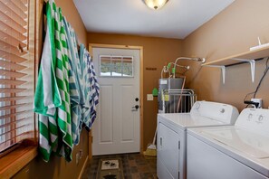 A laundry room with a washing machine, dryer, and a water heater. - Spacious Adventure Cabin with Direct Trail Access near Island Park, Idaho (Island Park)