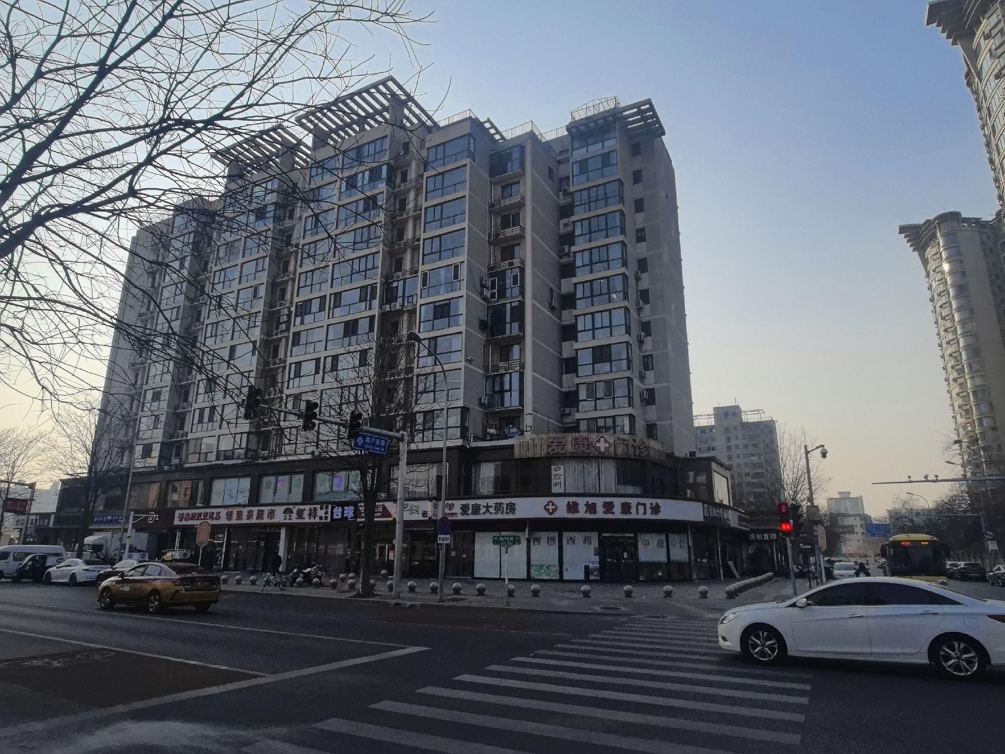 A multi-story building with commercial establishments on the ground floor.