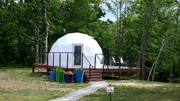 A dome-shaped tent with a deck and outdoor seating, surrounded by trees. - Unique Glamping Dome with Private Firepit Luxury Escape in Salt Lick, Kentucky (Salt Lick)