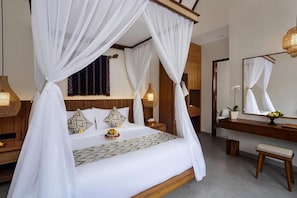 A bedroom with a four-poster bed, a bedside table, a nightstand, a mirror, and a bench. - Jenna Villa by Genuinehost (Ubud)