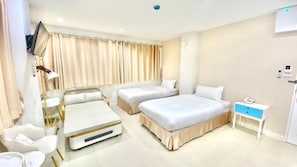A hotel room with two beds, a desk, a chair, a TV, and a bedside table. - Abcyq Hotel Bangkok (Bangkok)
