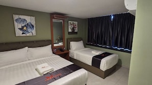 A hotel room with two beds, a nightstand, a mirror, and a window with curtains. - Enrich Hotel Semenyih (Semenyih)