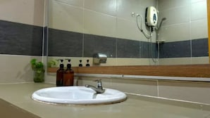 A bathroom with a white sink, a mirror, a handheld showerhead, and a soap dispenser. - Lilla Sea View Retreat, Malacca (Alor Gajah)