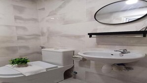 A bathroom with a toilet, bidet, and sink. - Swing And Pillows at ICC Pudu (Kuala Lumpur)
