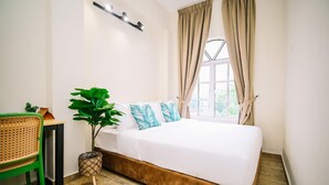 A bedroom with a bed, a potted plant, a chair, and a window with curtains. - Swing And Pillows at ICC Pudu (Kuala Lumpur)