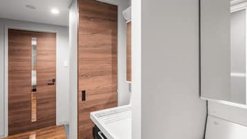 A modern kitchen with a wooden floor, a white countertop, and a built-in oven.