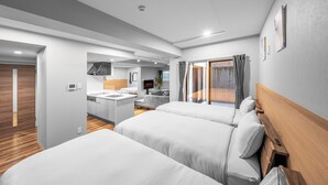 A modern hotel room with two beds, a kitchenette, a bathroom, and a view of the outdoors. - NOBLE 202 (Sapporo)