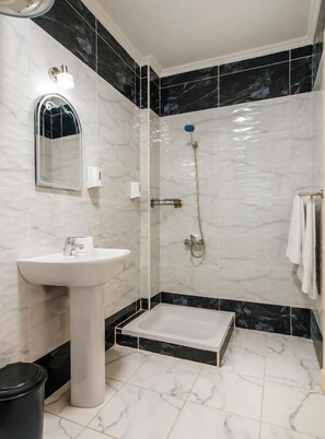 A bathroom with a pedestal sink, a shower enclosure, and a bathtub. - Peaks - El Nessim-1BR-Pool View R106 (Hurghada)