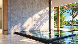 A modern interior with a pool, stone walls, and a wooden ceiling. - Mangrove Resort Phuket Airport (Thalang)