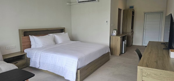 A bedroom with a bed, bedside tables, a wardrobe, and a television.