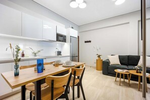 A modern kitchen with white cabinets, a built-in microwave, and a stainless steel refrigerator. - FiftySeven Athens - Spacious 2BR, Terrace | 103 (Athina)