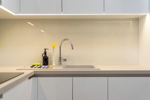 A modern kitchen with a stainless steel sink, a faucet, and a soap dispenser. - FiftySeven Athens - Terrace Days, 2BR | 102 (Athina)