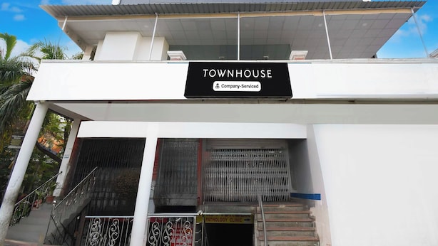 A building with a sign reading 'TOWNHOUSE' and a 'Company-Serviced' label. - Townhouse Vrindavan Yojna Lucknow (Lucknow)