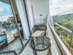 A balcony with a glass table and chairs, a view of the cityscape, and a railing. - Cozy 1-bedroom apartment with gym, swimming pool in fabulous Nairobi Lavington (Nairobi)