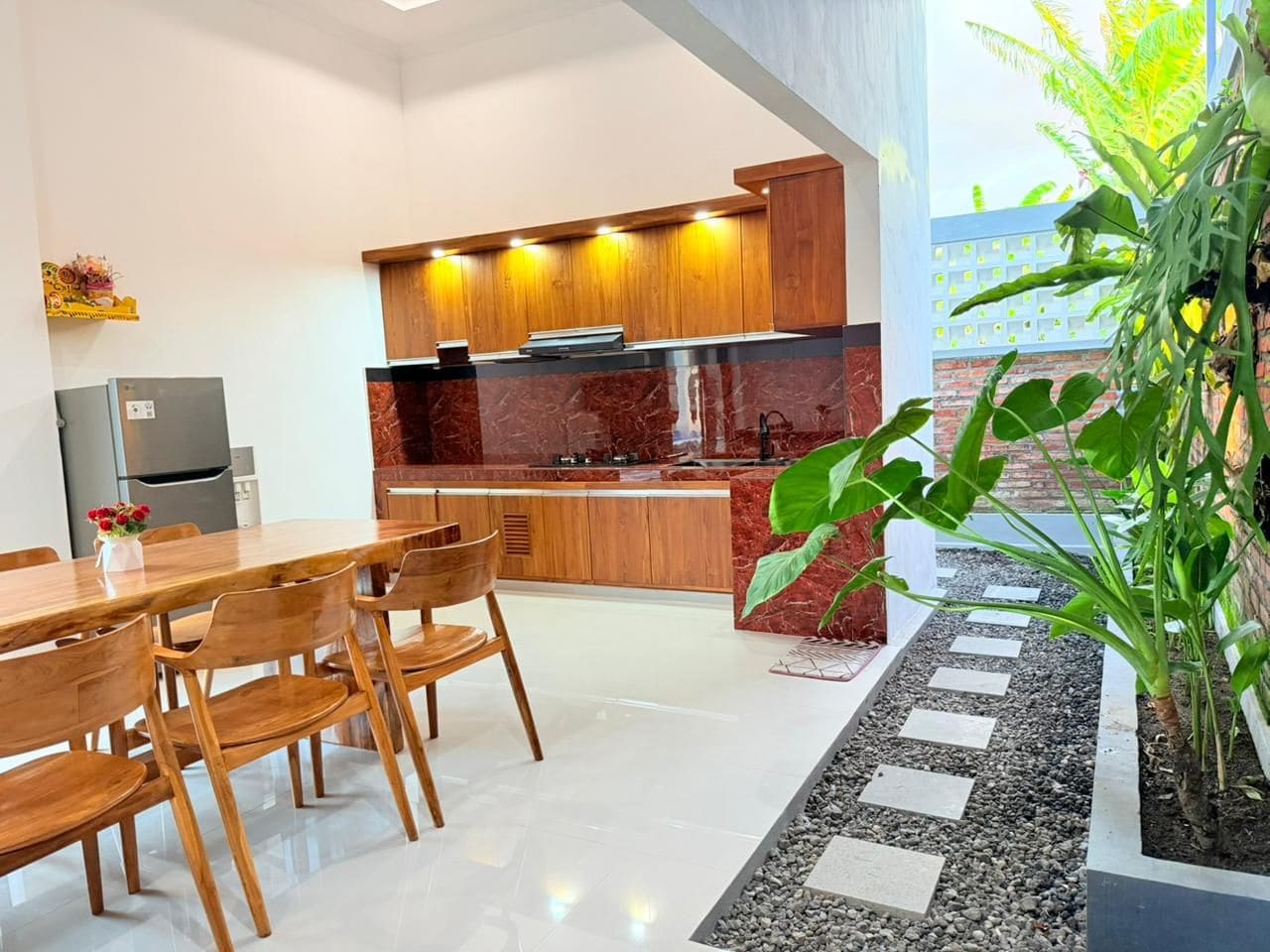 Una cocina moderna con armarios de madera y encimera de mármol.