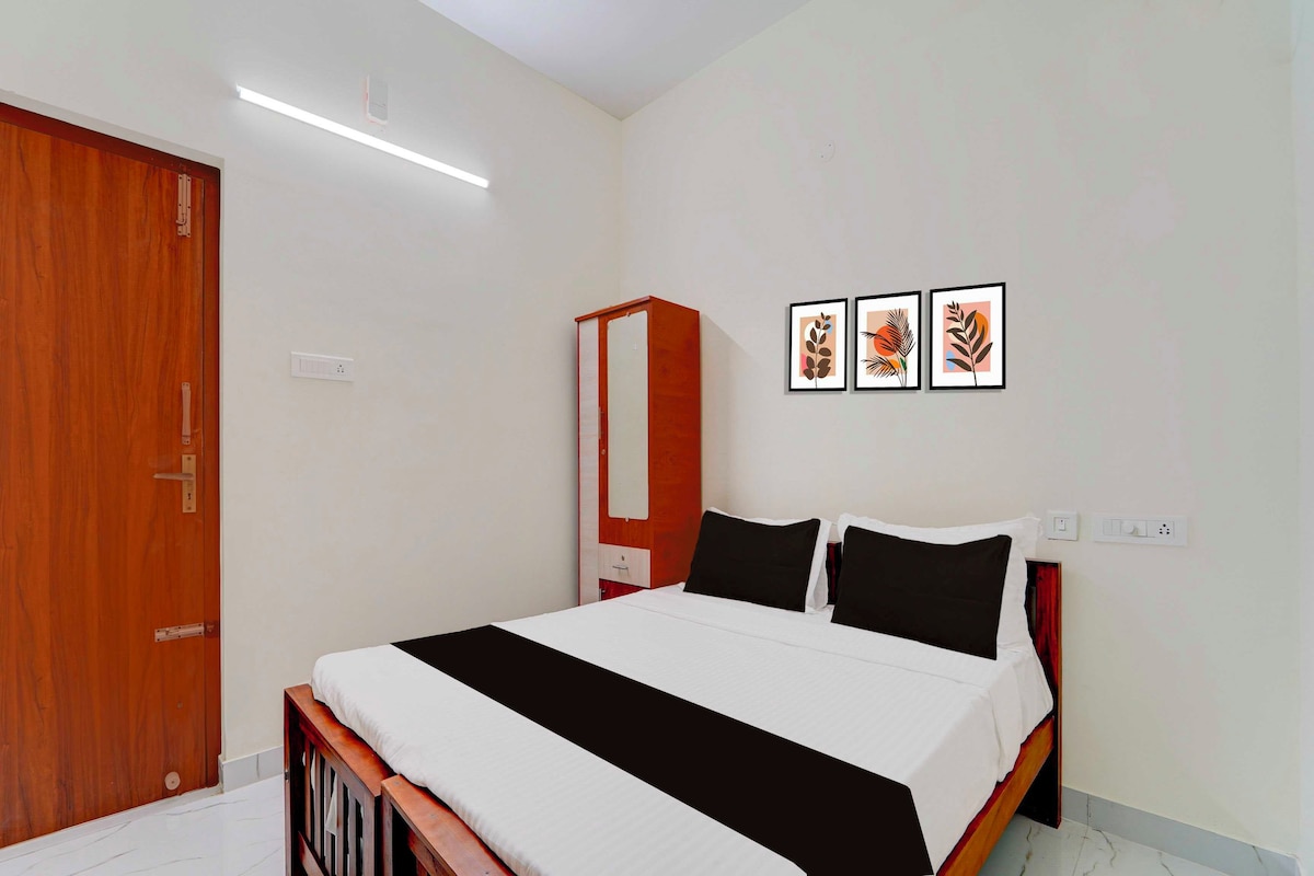 Un dormitorio con cama, armario y tres cuadros en la pared.