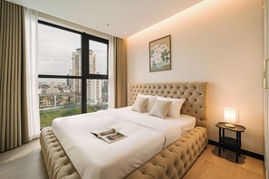 A hotel room with a large bed, a view of the city, and a nightstand with a lamp. - The Nelson Luxury 3BR Apartment in Lang Ha street – Free Pool, Gym & Sauna (Hà Nội)