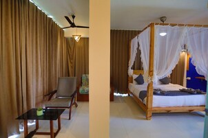 Um quarto com cama, cadeira, mesa e cortinas.