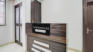 A reception area with a sign indicating 'TOWNHOUSE Company-Serviced'. - Townhouse Faizabad Road Opp BBD (Lucknow)
