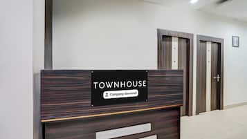 A reception desk with a sign indicating 'TOWNHOUSE' and 'Company-Serviced.'
