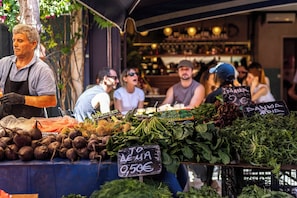 A market stall with fresh produce and a sign indicating a price of 0.50€. - FiftySeven Athens - City Pulse, Balcony | 004 (Athina)