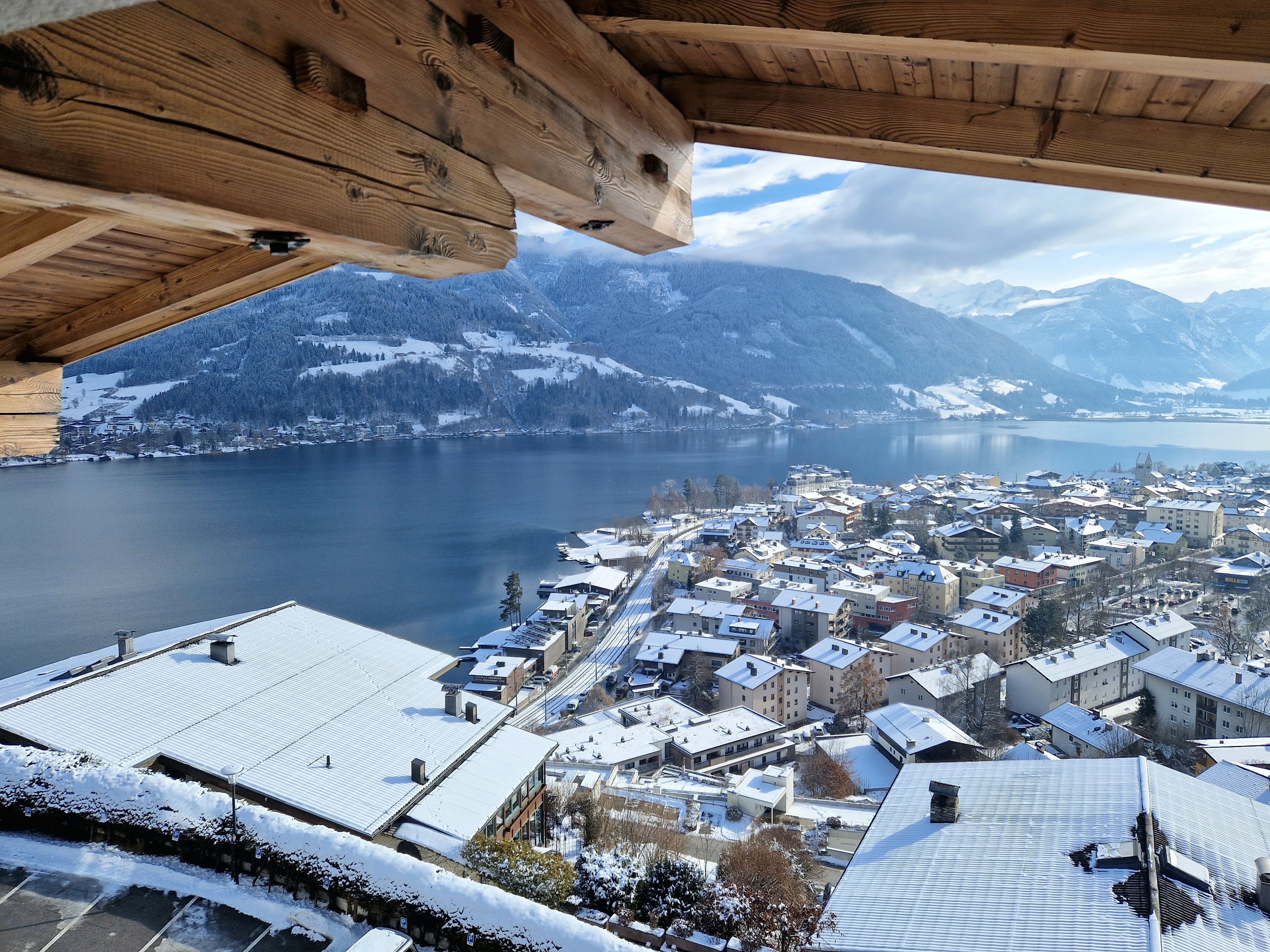A town with snow-covered buildings and a lake.