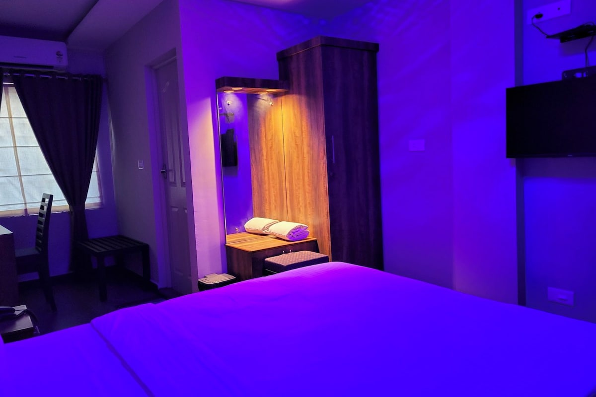 Un dormitorio con cama, escritorio, silla y armario.
