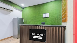 Un comptoir d’accueil avec une pancarte indiquant : « TOWNHOUSE & Company, services inclus ».