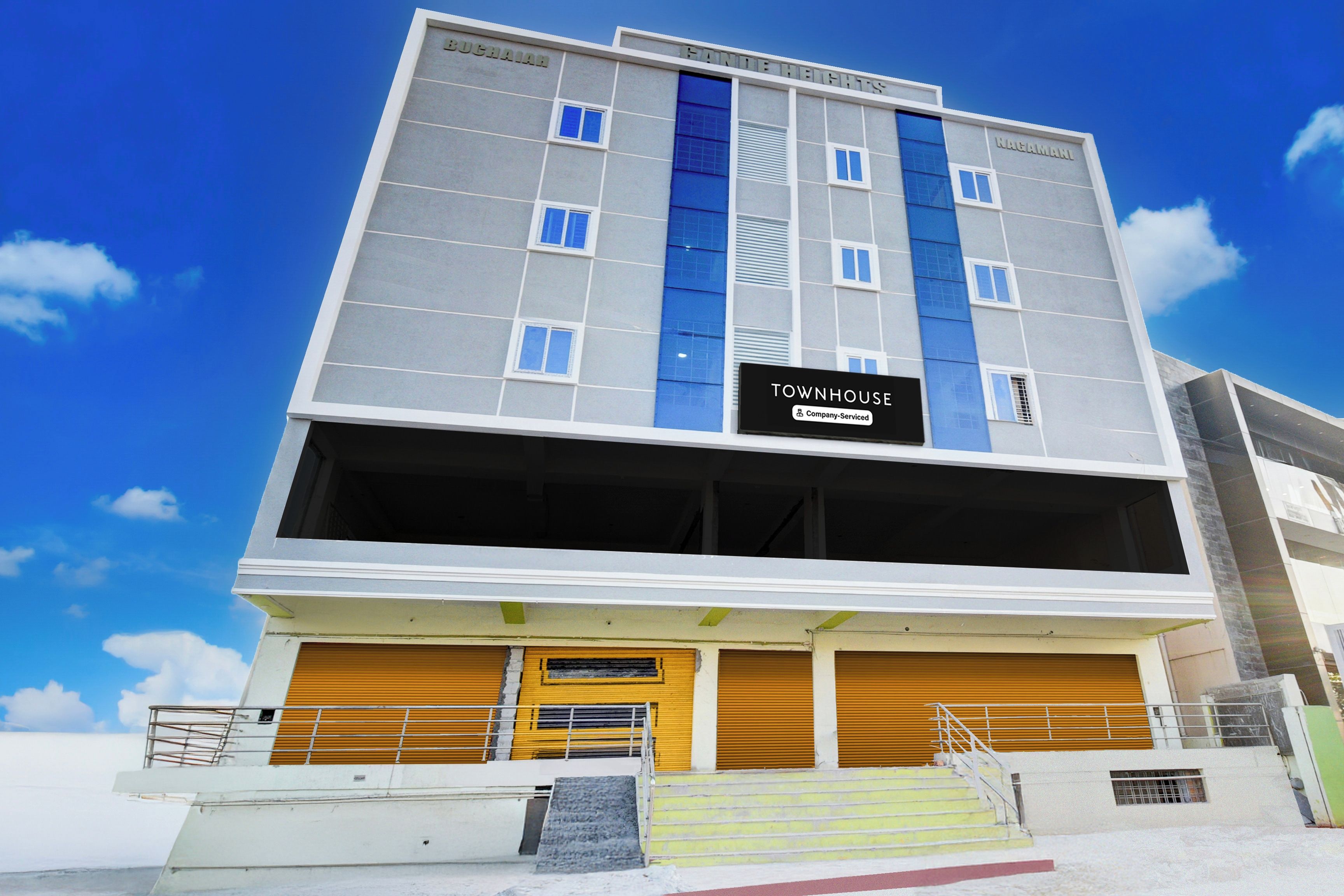 A multi-story building with a sign indicating it is a company-serviced townhouse.