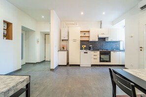 A modern kitchen with white cabinetry, a built-in oven, and a countertop with a sink. - A comfortable and bright 74 square meters apartment, perfect for four people, located on the second floor of a period building (no elevator).The property is situated near the Ospedale Maggiore in Trieste and a short distance from the city center; guests  (Trieste)
