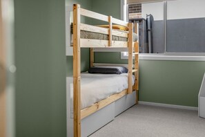 A bunk bed with a window above it, a radiator, and a white wall. - Beach & Bath - Torquay Family Getaway (Surf Coast)