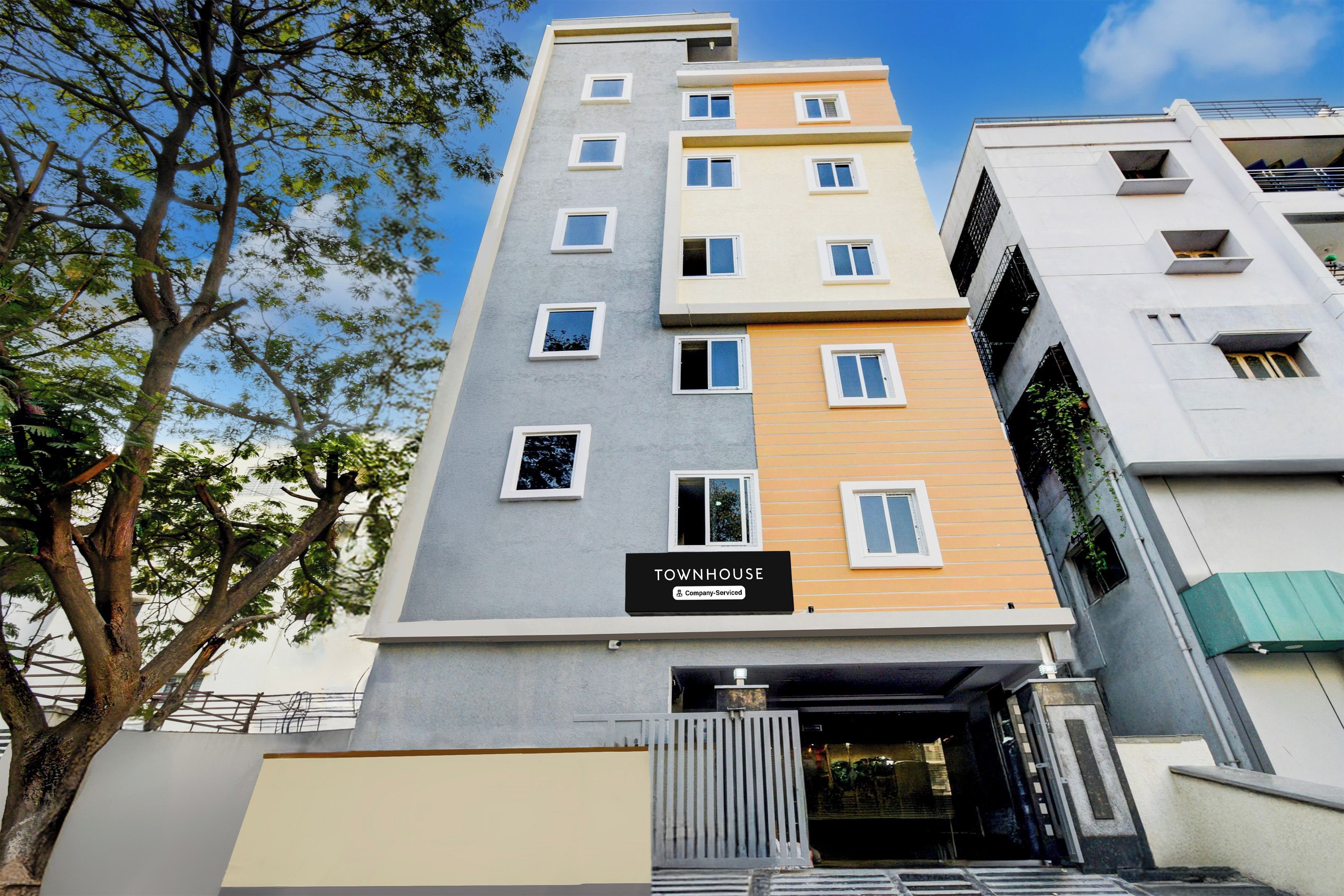A multi-story building with a sign indicating it is a serviced company property.