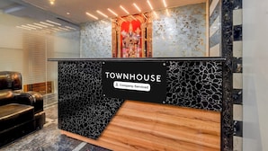 Una recepción con un letrero que dice 'TOWNHOUSE', indicando una propiedad de servicio de empresa.