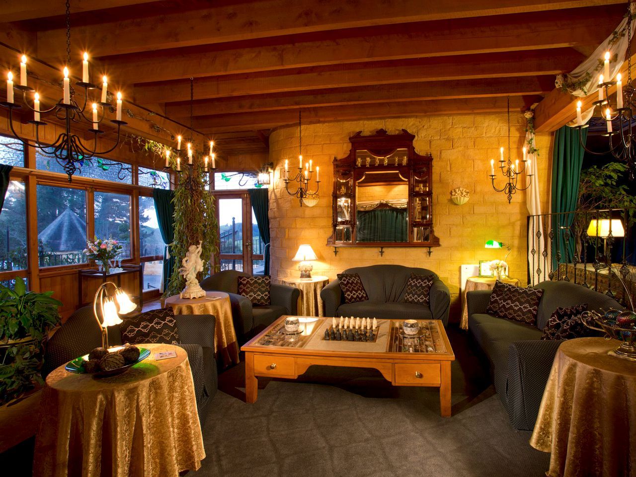 A cozy room with a fireplace, wooden furniture, and a chessboard.