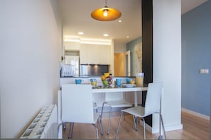 A modern kitchen with white cabinets, a central island with seating, and a hanging light fixture. - Apartment with Balcony near Sagrada Familia – Aragón 528Perfect for families, getaways with friends, or romantic weekends, this cozy three-bedroom, two-bathroom apartment offers everything you need to enjoy Barcelona like a true local. Just steps from (Barcelona)