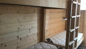A bunk bed with a mattress and wooden headboard. - Apartment in Les Arcs 1800 for 8 people (Bourg-Saint-Maurice)