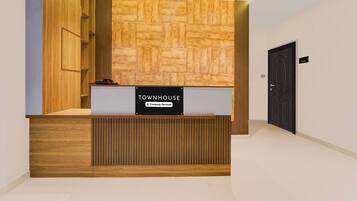 A reception desk with a sign reading 'TOWNHOUSE Company Serviced.'