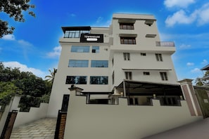 A multi-story building with a sign indicating it is a serviced company property.