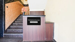 A reception desk with a sign that reads 'TOWNHOUSE Company Serviced.' - Townhouse Puri Former Hotel Narashingha (Puri)