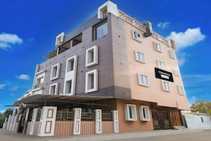 A multi-story building with a sign indicating it is a company serviced townhouse. - Townhouse Puri Former Hotel Narashingha (Puri)
