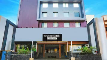 A multi-story building with a sign indicating 'TOWNHOUSE OAK' and 'Company-Serviced' accommodation.