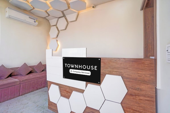 A reception area with a sign reading 'TOWNHOUSE Company-Serviced.'