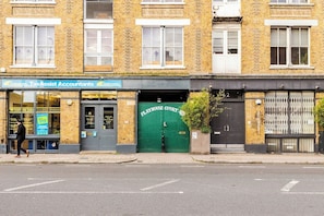 A building with a storefront named 'TaxAssist Accountants' and a green door labeled 'Playhouse Court.'
