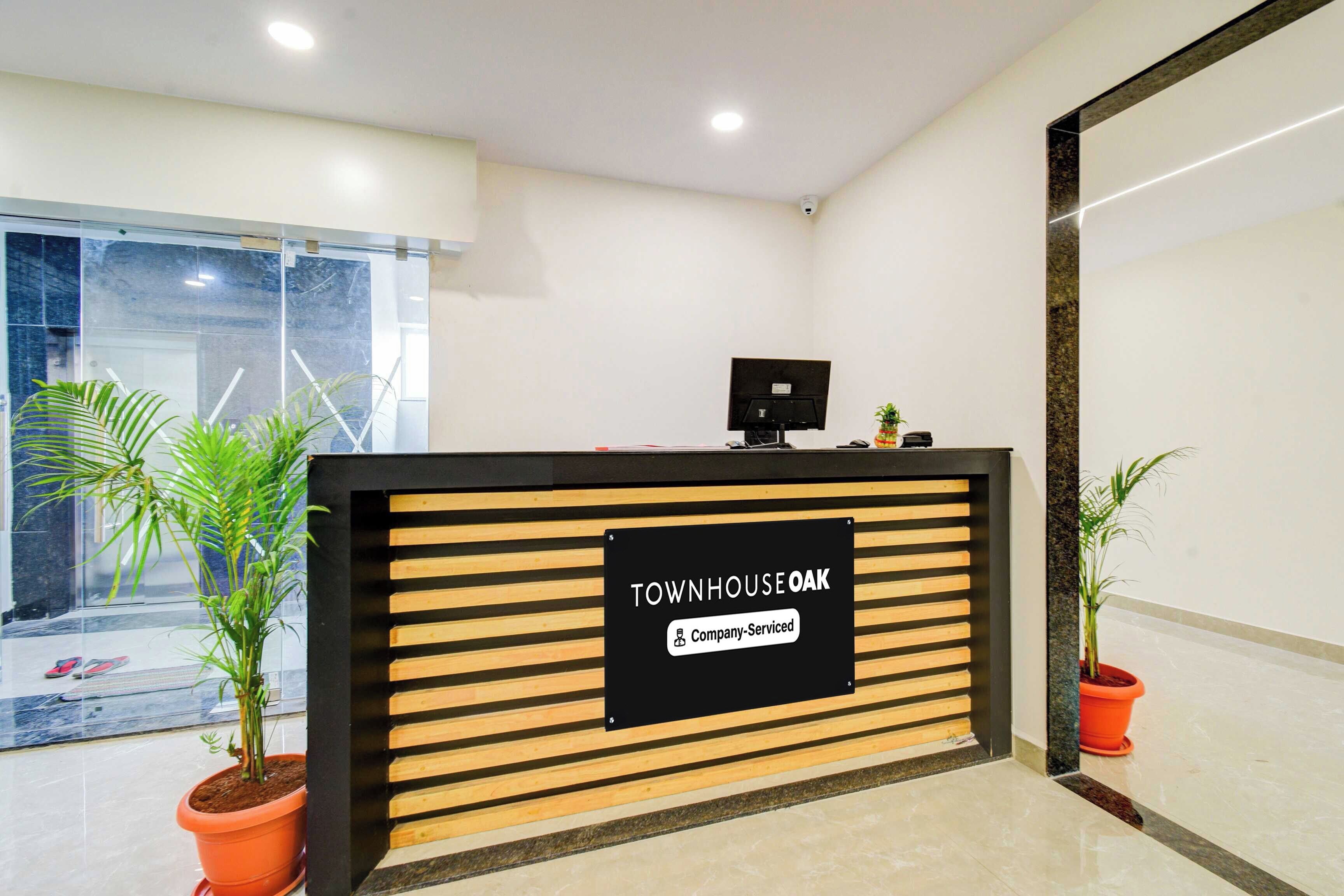 A reception desk with a sign indicating it is company-serviced.