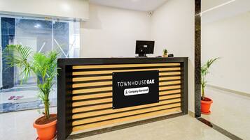 A reception desk with a sign indicating it is company-serviced.