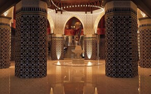 A spacious lobby with high, ornate columns and a central fountain. - Palmeraie Golf Palace by Pickalbatros (Marrakech)